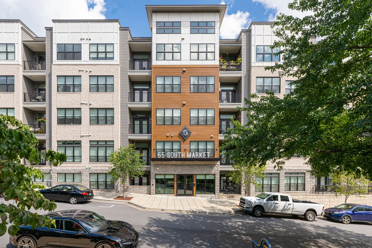 This image showcases the modern exterior of the condo building, emphasizing the entrance canopy, large windows, and inviting signage. The visual highlights secure and welcoming access into the building for residents and guests.